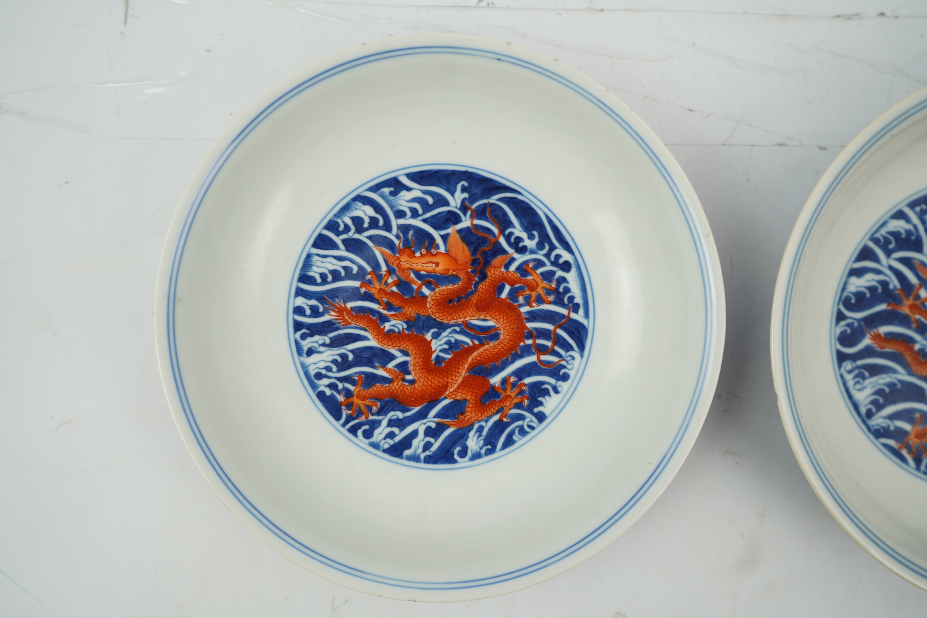 A pair of Chinese iron red and underglaze blue ‘dragon’ dishes, Qianlong seal mark and of the period (1736-95)